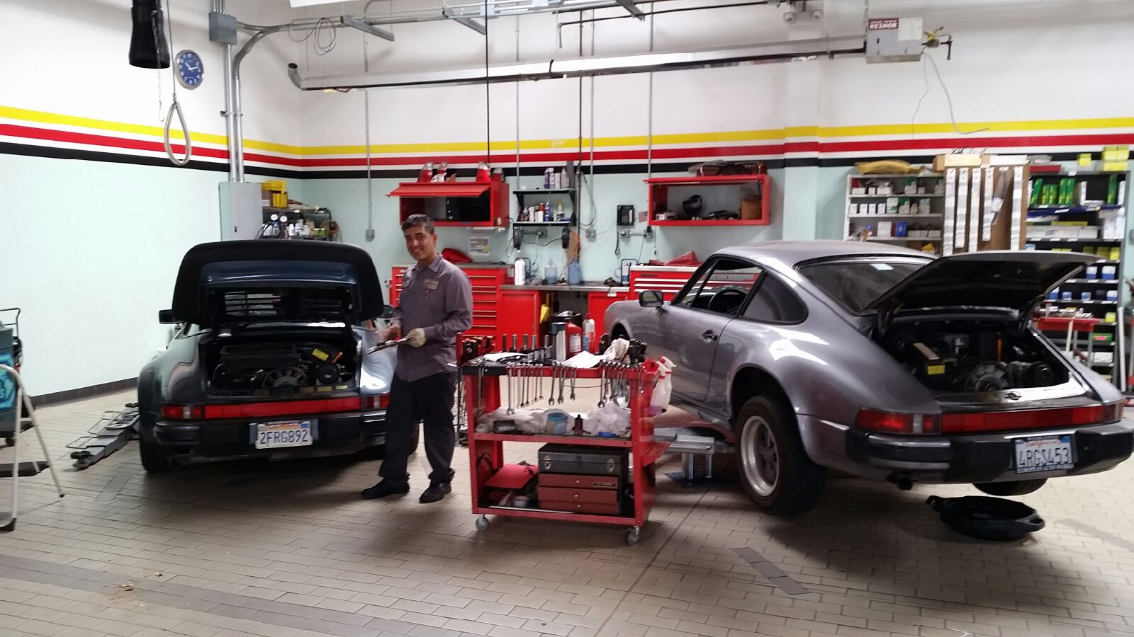 Nasseri Auto Tech repair shop with two classic Porsche 911s on the floor